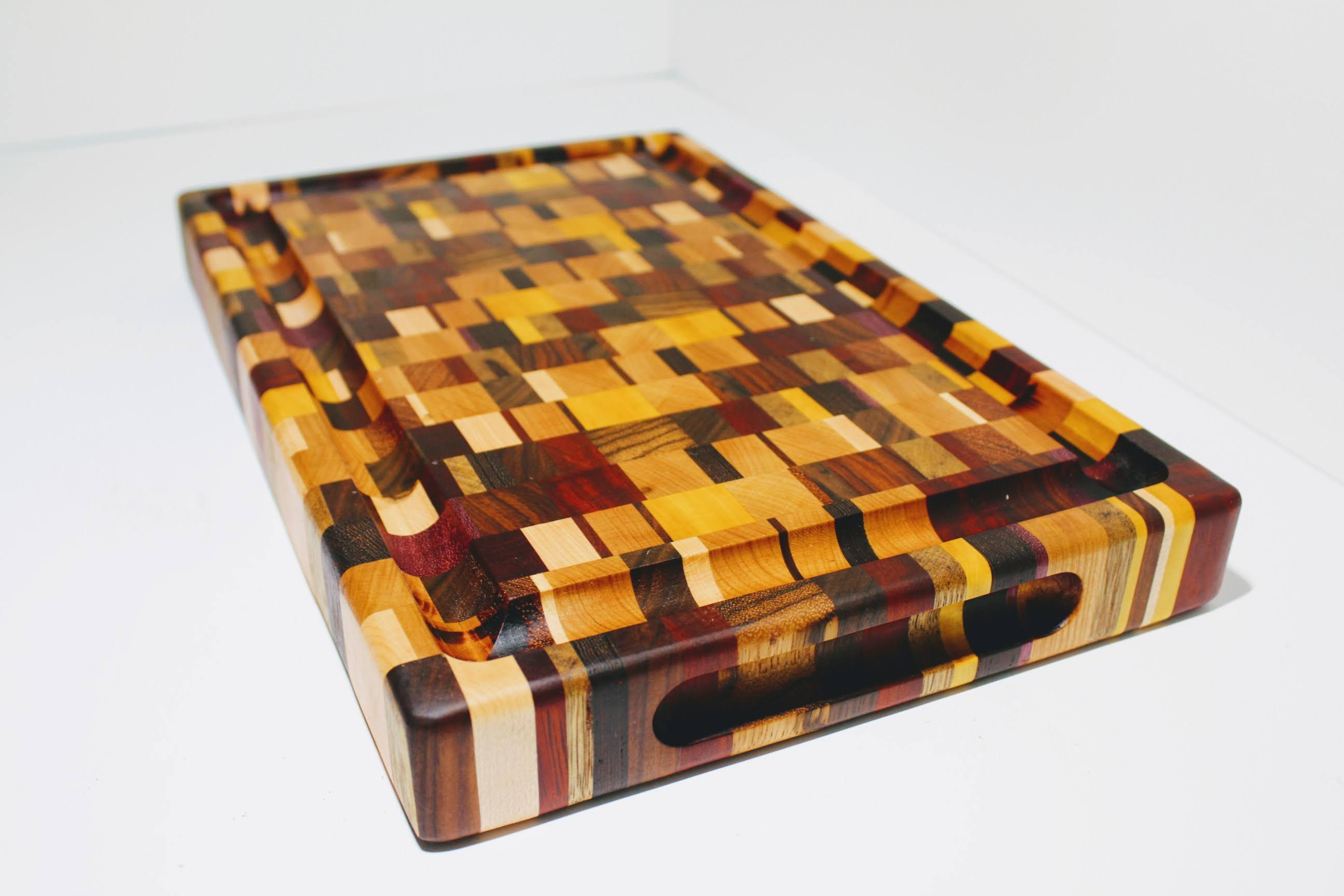 Wooden cutting board with a checkered pattern on a white background
